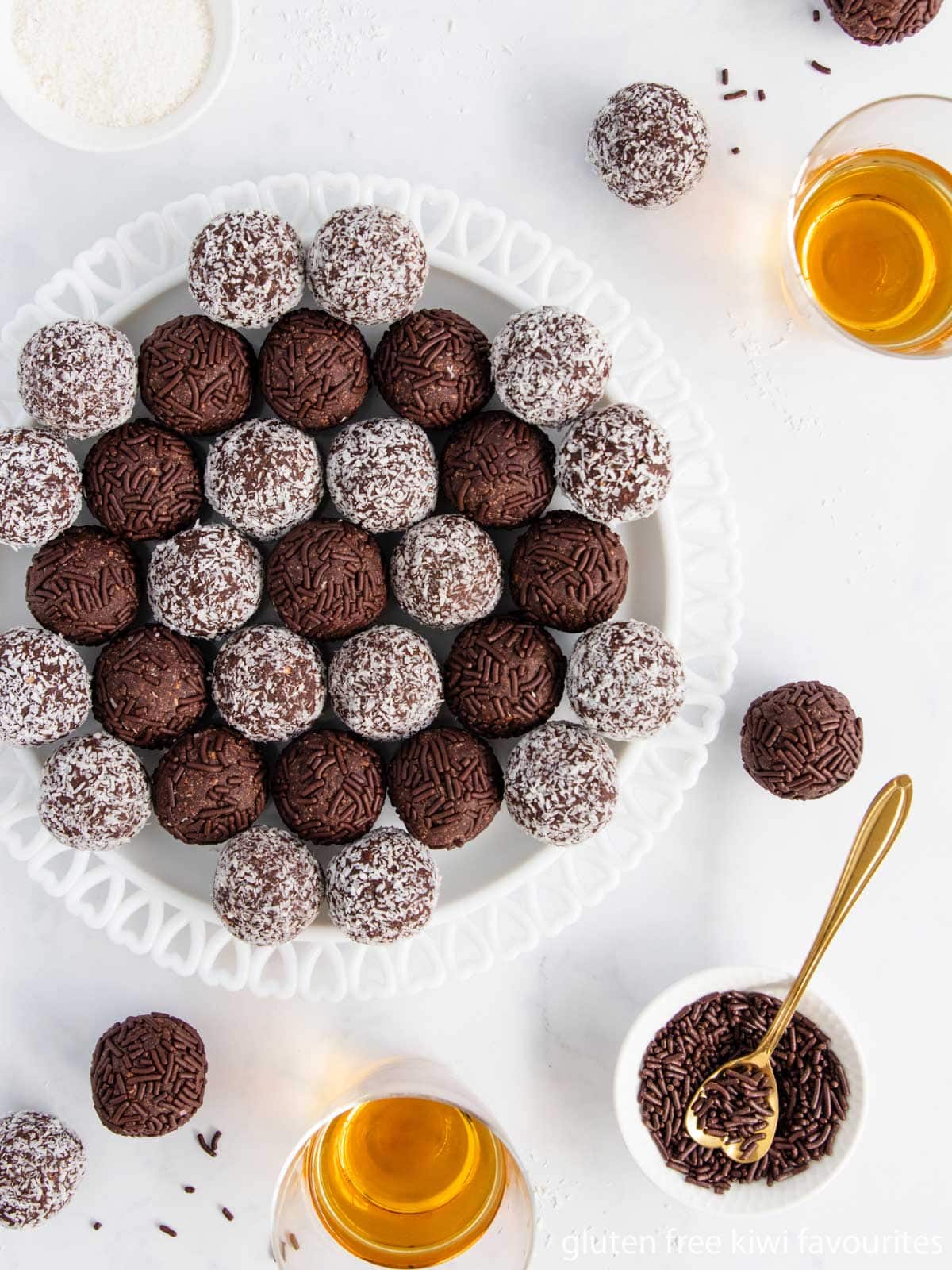 Rum balls arranged in a circular pattern on a white plate.