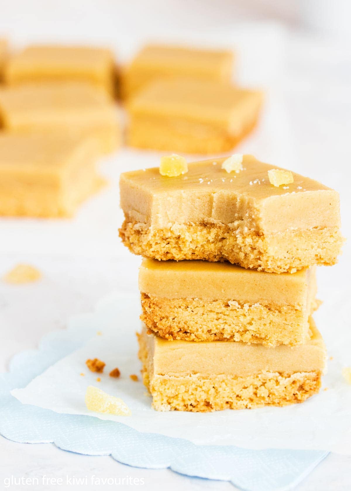 Three stacked pieces of gluten free ginger crunch.