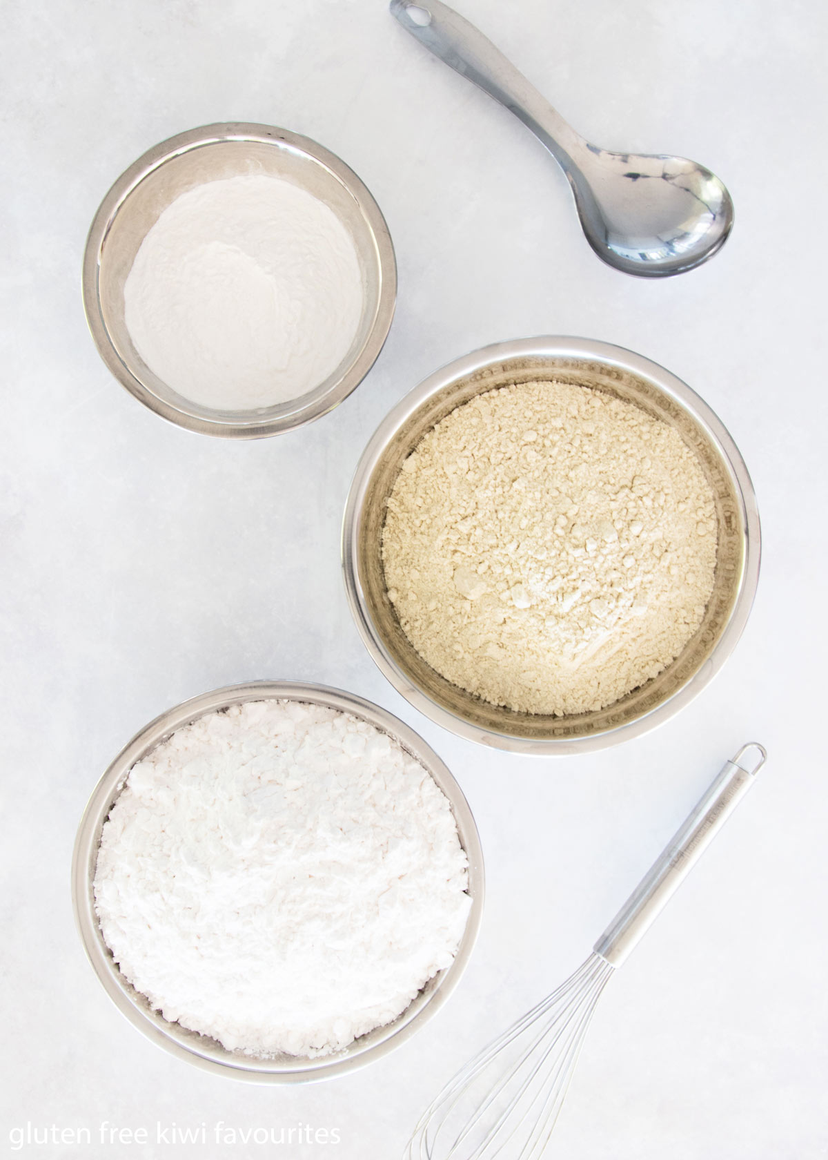 Gluten free flours in metal bowls - brown rice flour, tapioca starch and potato starch.