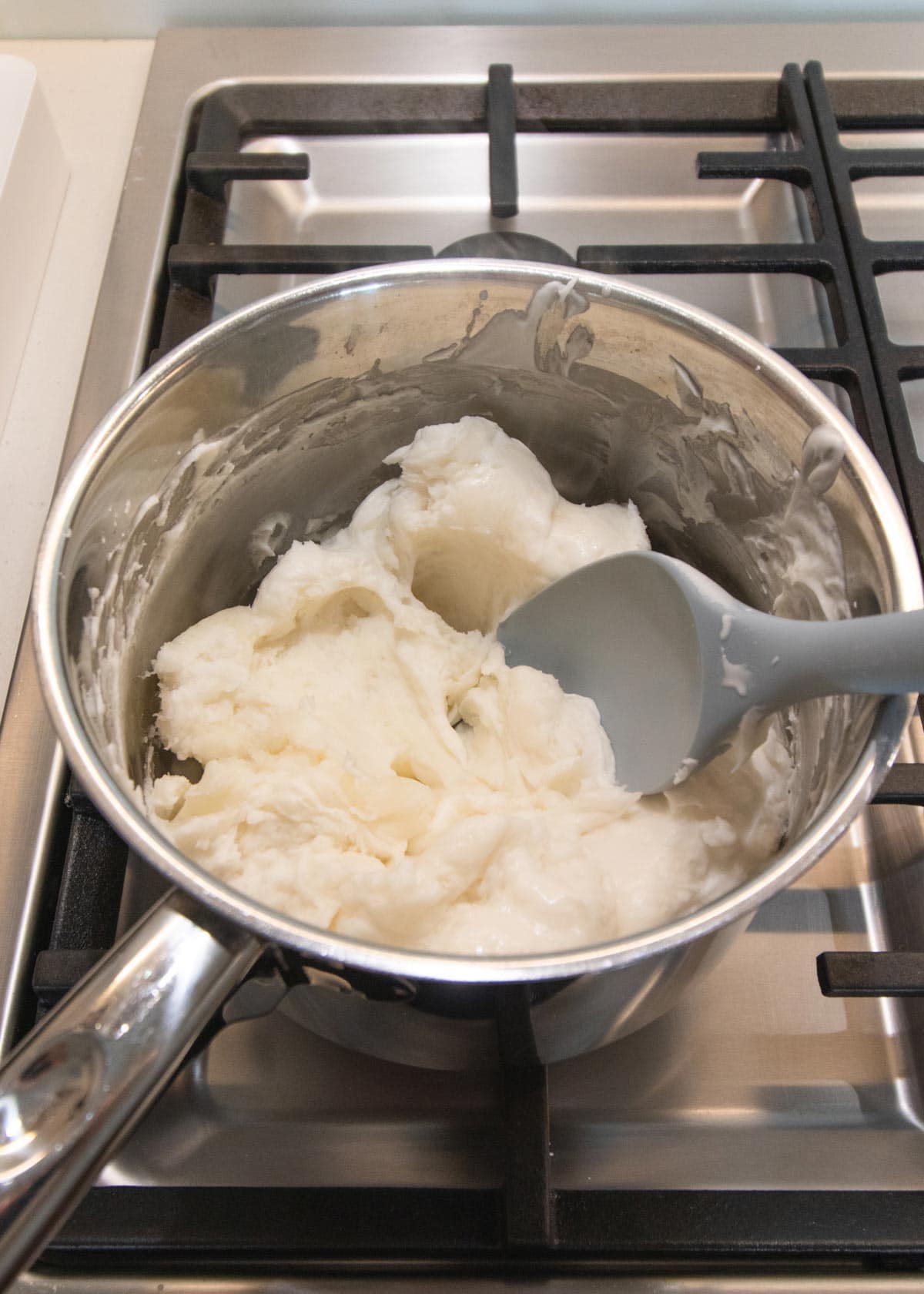 The playdough being cooked on the stove, until very thick.