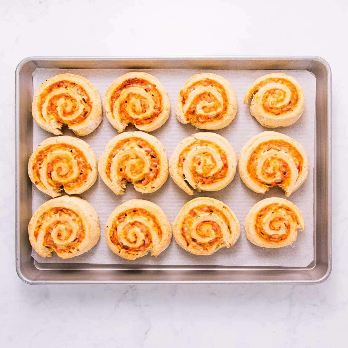The baked scrolls on a baking tray. 