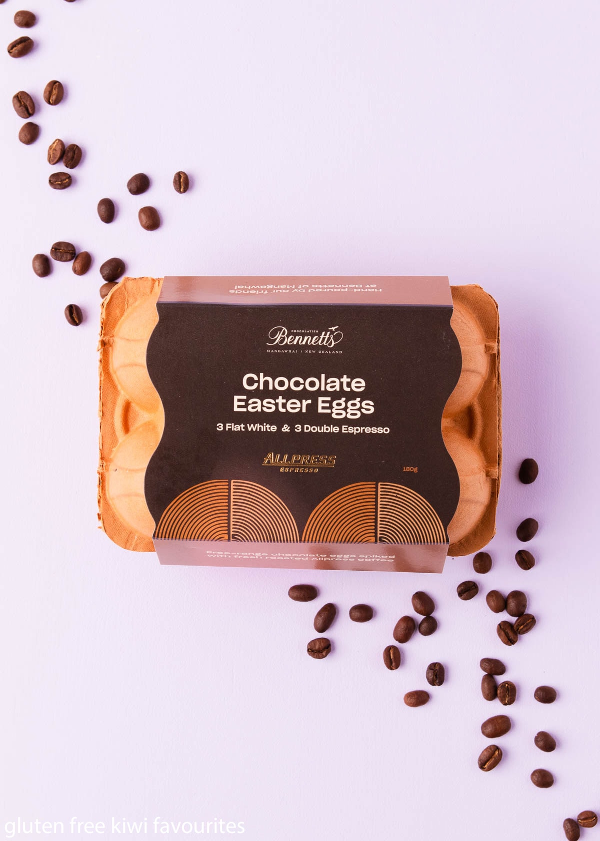 Allpress Espresso chocolate eggs by Bennetts of Mangawhai in a brown egg carton on a light purple background.