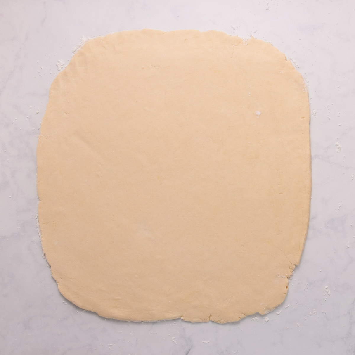 The dough rolled out into a large square.