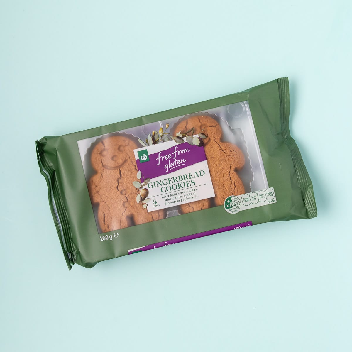 A packet of Free From Gluten gingerbread cookies on a mint green background.