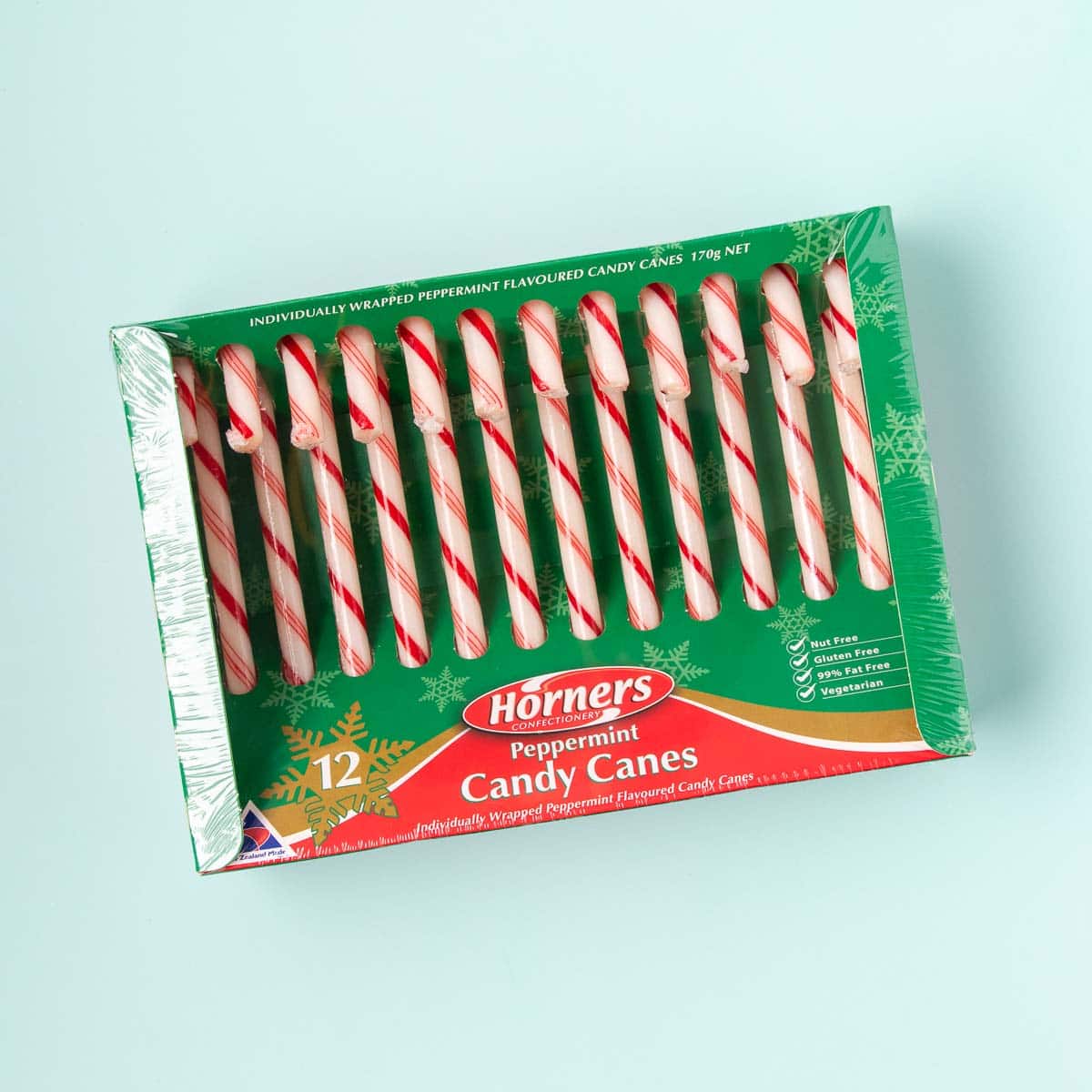 A box of 12 Horners candy canes, on a mint green background.