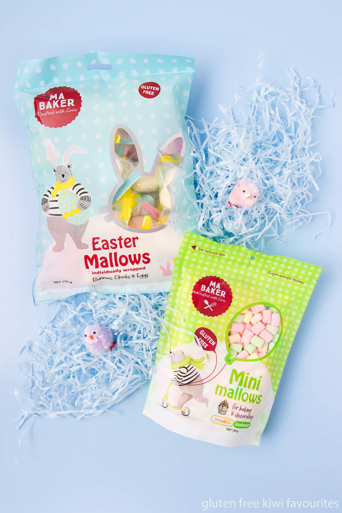 A bag of Ma Baker brand Easter marshmallows and multi-colour mini mallows on a blue background.