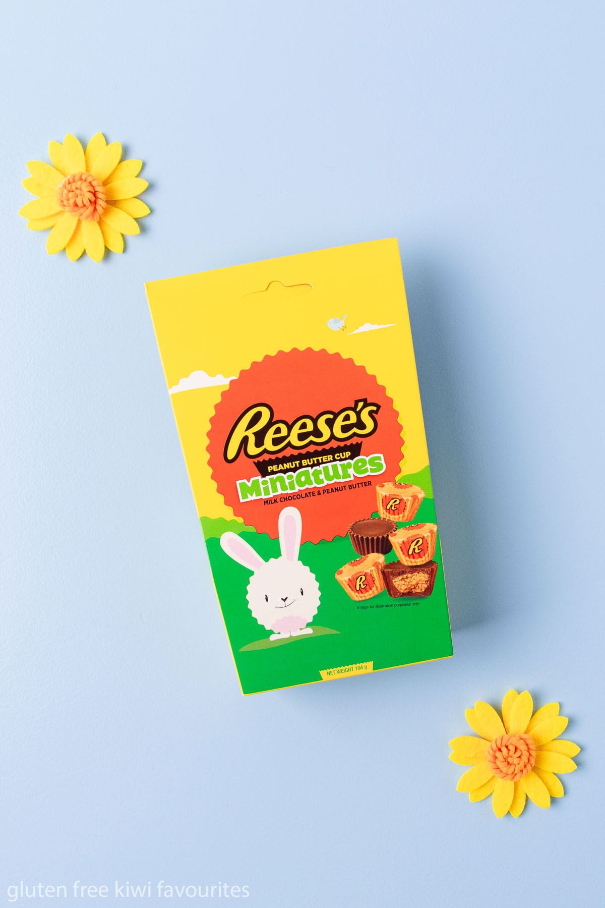A box of Reese's miniature peanut butter cups on a blue background.