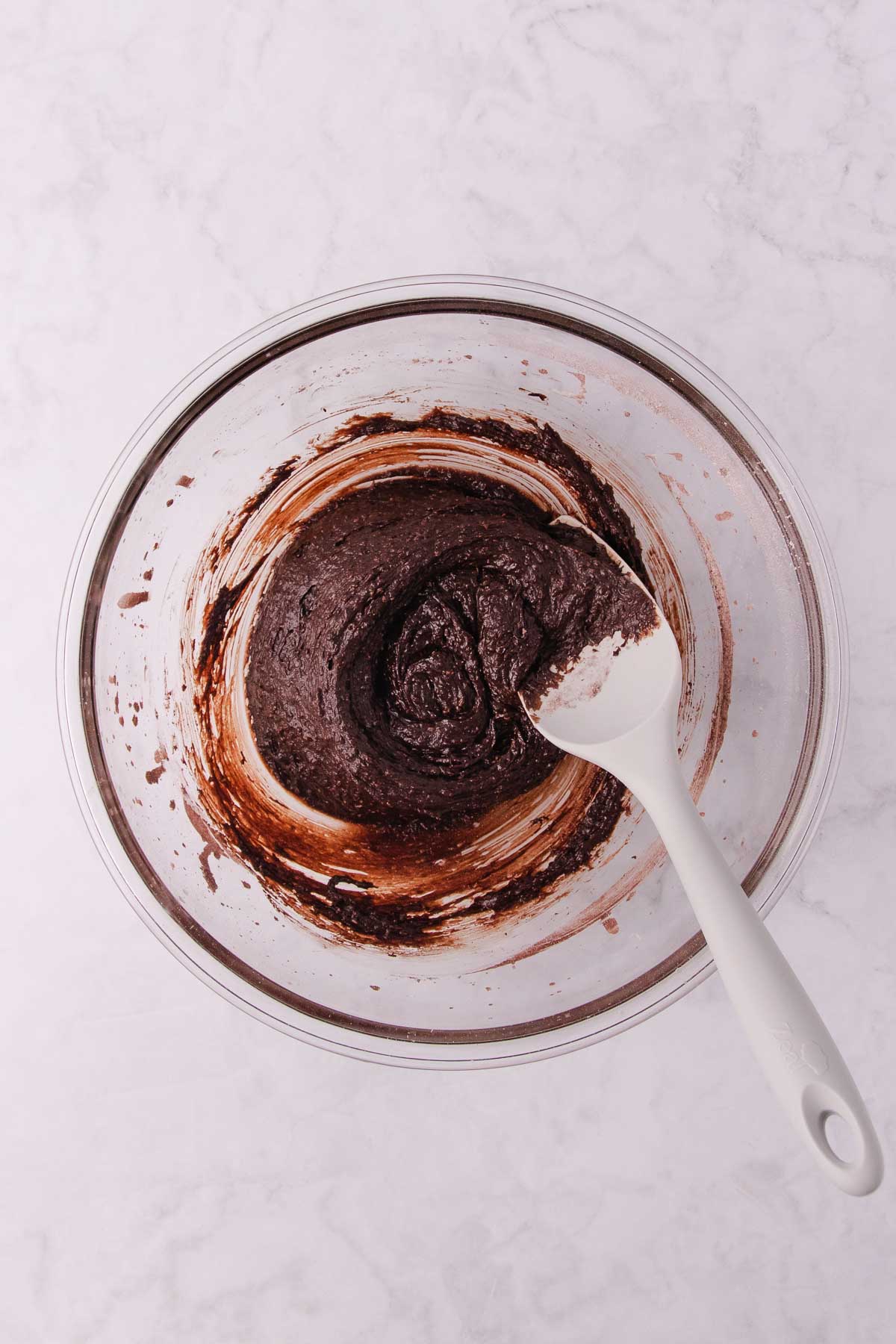 The peppermint slice base batter being mixed with a large silicon spatula.