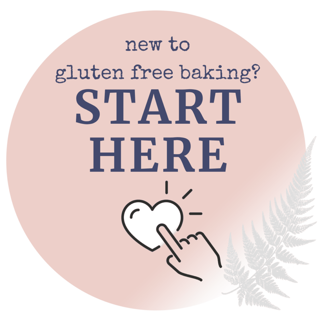 A rose pink circle with a small icon of a finger tapping a heart, with text reading "new to gluten free baking? Start here".